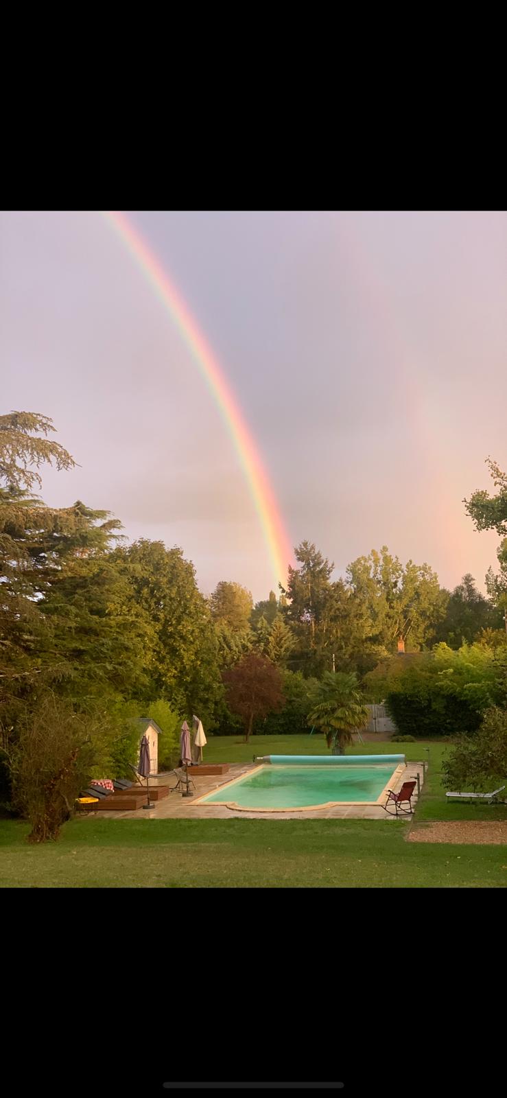 Château Eden with rainbow over pool
